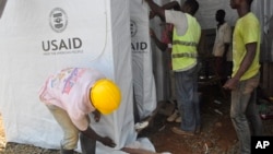 People construct a new Ebola treatment centre in Monrovia, Liberia,Oct. 10, 2014.