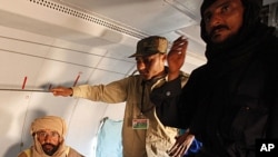 Saif al-Islam Gadhafi is pictured sitting in a plane in Zintan, Libya, November 19, 2011.