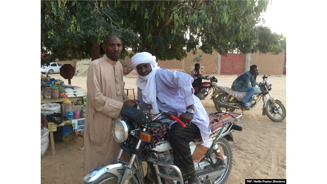 Local men pose for a photo on a downtown street corner, Agadez, Niger, Feb. 20, 2018.