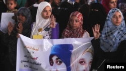 Supporters of ousted Egyptian President Mohamed Morsi rally against the military and interior ministry, as they show the "Rabaa" gesture, a sign to condemn police killing of hundreds of protesters.