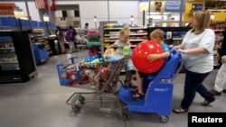 FILE - A family shops at a Wal-Mart Supercenter store in Springdale, Arkansas, June 4, 2015.