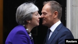 Britain's Prime Minister Theresa May greets European Council President Donald Tusk outside 10 Downing Street in London, March 1, 2018.