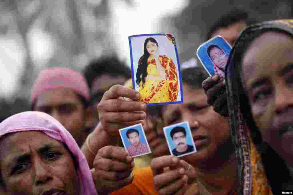 Relatives show pictures of garment workers who are missing, during a protest to demand capital punishment for those responsible for the collapse of the Rana Plaza building, in Savar, outside Dhaka.