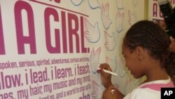 An American girl in Chicago, Illinois signs onto the 'Girl Up' campaign which helps less fortunate girls in other countries.