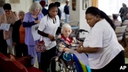 Elderly and disabled South African voters, assisted by nurses, cast their ballots during early voting for special groups at the Nazareth House old-age home in Johannesburg, South Africa, May 5, 2014.
