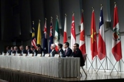 FILE - Officials representing countries of the Pacific Rim trade bloc attend a joint press conference after a session of the Comprehensive and Progressive Agreement for Trans-Pacific Partnership (CPTPP) in Tokyo, Japan, Jan. 19, 2019.