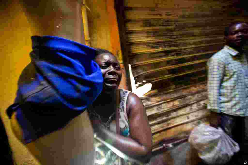 A vendor salvaging her mannequin wearing a skirt runs away from her&nbsp; burning stall during a massive fire at the biggest clothing market in Port-au-Prince, Haiti, Feb. 18, 2018.