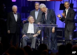 FILE - Former presidents from right, Barack Obama, Bill Clinton, George W. Bush, George H.W. Bush and Jimmy Carter gather on stage during a hurricanes relief concert in College Station, Texas, Oct. 21, 2017. AP Photo/LM Otero)