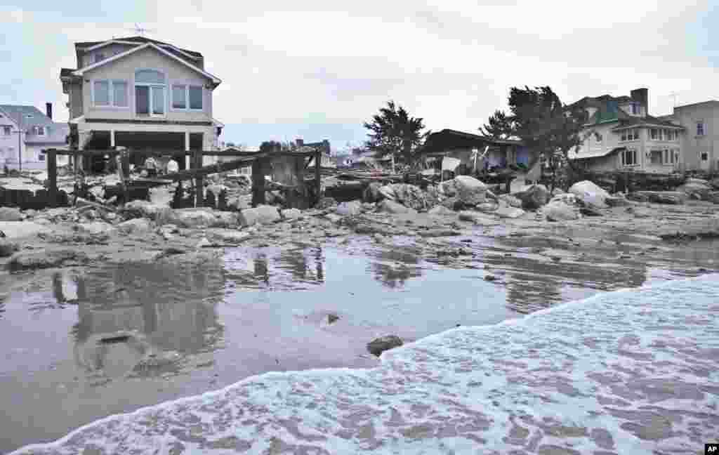 A beachfront house is damaged in the aftermath of yesterday's surge from superstorm Sandy, Oct. 30, 2012, in Coney Island's Sea Gate community in New York.