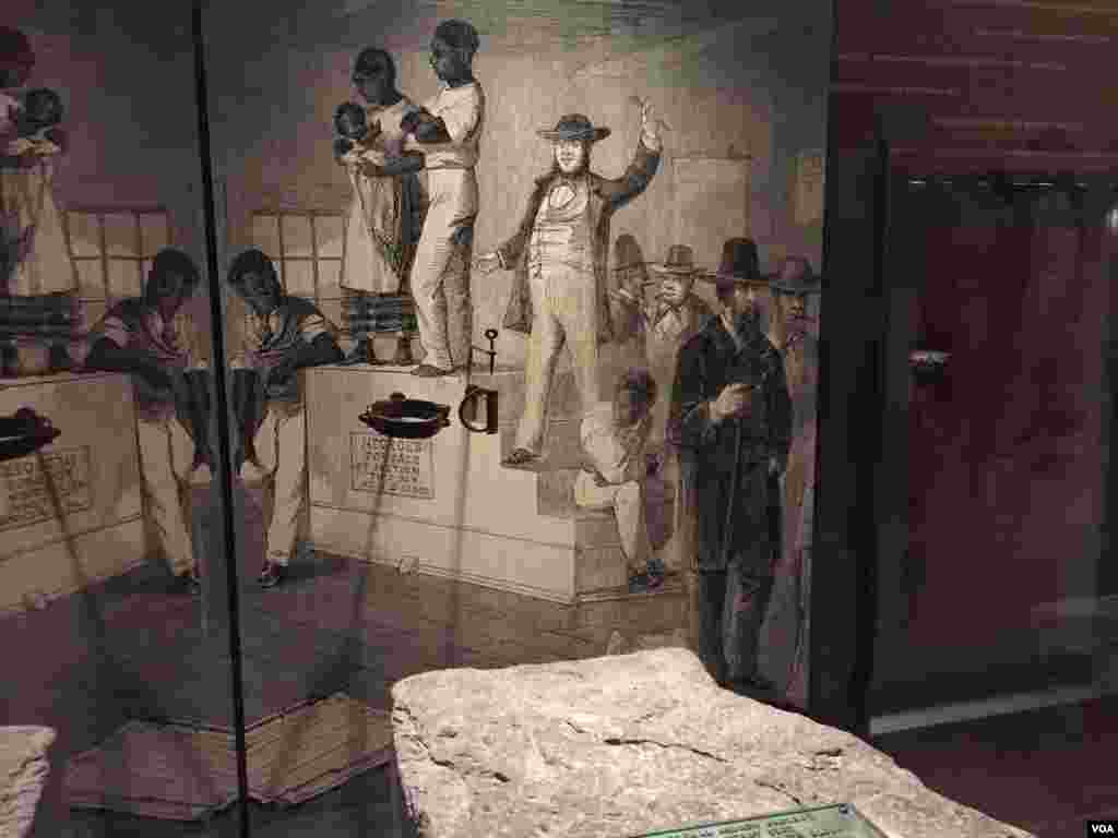 A stone slave auction block from Hagerstown, Maryland, is displayed at the Smithsonian National Museum of African American History & Culture in Washington, D.C. (C. Simkins/VOA)