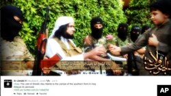 FILE - This screen grab from an Islamic State group affiliated Twitter account, taken Sept. 20, 2014, purports to show senior military commander Abu Wahib handing a flower to a child, as part of the group's broad social media campaign. 