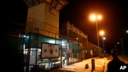 FILE - The entrance to Camp VI detention facility is guarded at Guantanamo Bay Naval Base, Cuba, Nov. 20, 2013.