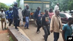 FILE: Police escorting protestors to a local magistrates court in Zimbabwe.