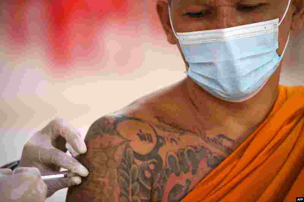 A Buddhist monk receives a dose of China&#39;s Sinovac coronavirus disease (COVID-19) vaccine at a temple in Bangkok, Thailand.