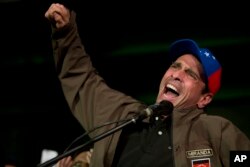 Venezuelan opposition leader Henrique Capriles speaks to supporters and reporters during a meeting in Caracas, April, 7, 2017. Capriles announced that he has been banned from running for office for 15 years.