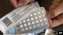FILE - A one-month dosage of hormonal birth control pills is displayed in Sacramento, Calif., Aug. 26, 2016.