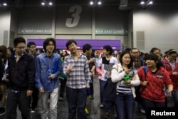 FILE - Students leave after a SAT exam at AsiaWorld-Expo in Hong Kong, Nov. 2, 2013.