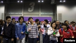 FILE - Students leave after a Scholastic Assessment Tests (SAT) exam at AsiaWorld-Expo in Hong Kong, Nov. 2, 2013. 