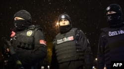 Police officers look on after a female suicide bomber died when she blew herself up in an attack on a police station in central Istanbul, the city governor said, Jan. 6, 2015.