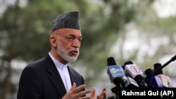 Afghanistan's former President Hamid Karzai speaks during a news conference in Kabul, Afghanistan, Tuesday, July 13, 2021. Former President Karzai calls on both the Afghan government and the Taliban to resume negotiations and end fighting in the country. (AP Photo/Rahmat Gul)