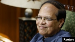 Bangladesh's central bank Governor Atiur Rahman smiles during an interview inside his office in Dhaka, October 2, 2013.