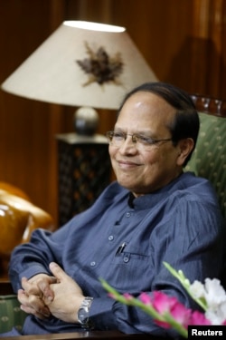FILE - Recently resigned Bangladesh central bank Governor Atiur Rahman smiles during an interview inside his office in Dhaka, October 2, 2013.