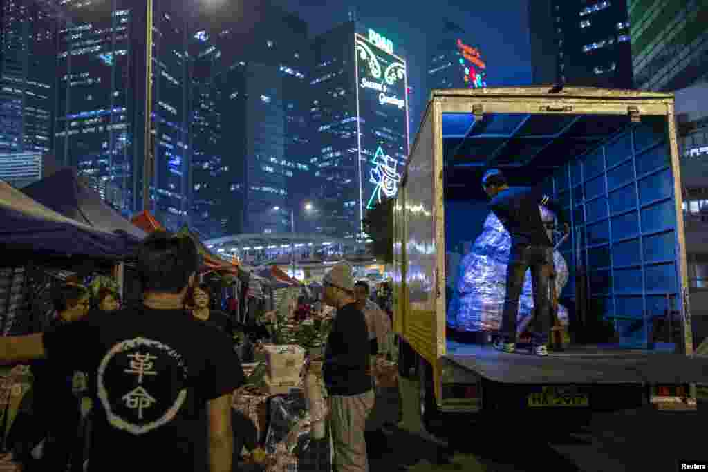 Pro-democracy protesters transport supplies outside the government headquarters in the Admiralty district of Hong Kong, Dec. 10, 2014.