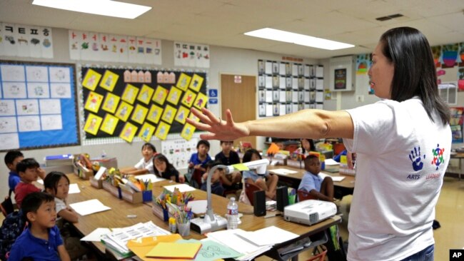 In this Sept. 30, 2016 photo, teacher Regina Yang leads a bilingual Korean-English language immersion classes at Porter Ranch Community School in Los Angeles.