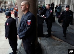Guards of the neo-Nazi National Socialist Movement stand nearby as Commander Jeff Schoep speaks at a rally, April 16, 2011, on the steps of the Statehouse in Trenton, New Jersey.