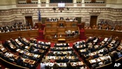 Greece's Prime Minister Alexis Tsipras addresses lawmakers on a controversial austerity bill during a parliamentary session in Athens, May 8, 2016. The bill passed early Monday morning.