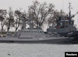 FILE - Seized Ukrainian ships, small armoured artillery ships and a tug boat, are seen anchored in a port of Kerch, Crimea November 26, 2018. REUTERS/Pavel Rebrov