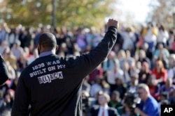 A member of the black student protest group Concerned Student 1950 gestures while addressing a crowd following the announcement that University of Missouri System President Tim Wolfe would resign, Nov. 9, 2015, at the university in Columbia, Missouri.