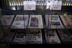 British national newspapers, with front pages reporting on the mob loyal to President Donald Trump storming the U.S. Capitol, are displayed for sale outside a store in London, Thursday, Jan. 7, 2021.