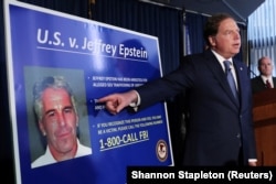 FILE: U.S. Attorney Geoffrey Berman, points to a photograph of Jeffrey Epstein as he announces the financier's charges of sex trafficking of minors and conspiracy to commit sex trafficking of minors, in New York, U.S., July 8, 2019.