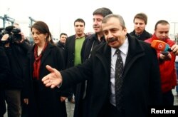 FILE - Pro-Kurdish politicians Sirri Sureyya Onder (R), Pelvin Buldan (L) and Altan Tan (C), are surrounded by media members before leaving for Imrali island in Istanbul, Feb. 23, 2013.