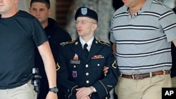 Army Pfc. Bradley Manning, center, is escorted out of a courthouse in Fort Meade, Md., June 17, 2013.