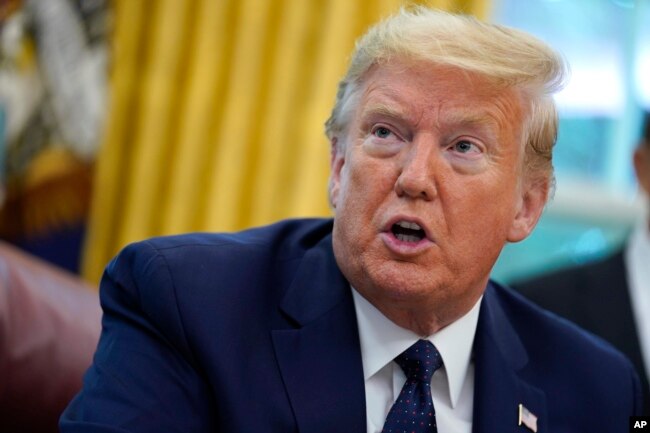 FILE - In this May 28, 2020 file photo, President Donald Trump speaks as he receives a briefing on the 2020 hurricane season in the Oval Office of the White House in Washington. The United States is out of the Paris climate agreement on the day after the presidential election. (AP Photo/Evan Vucci, File)