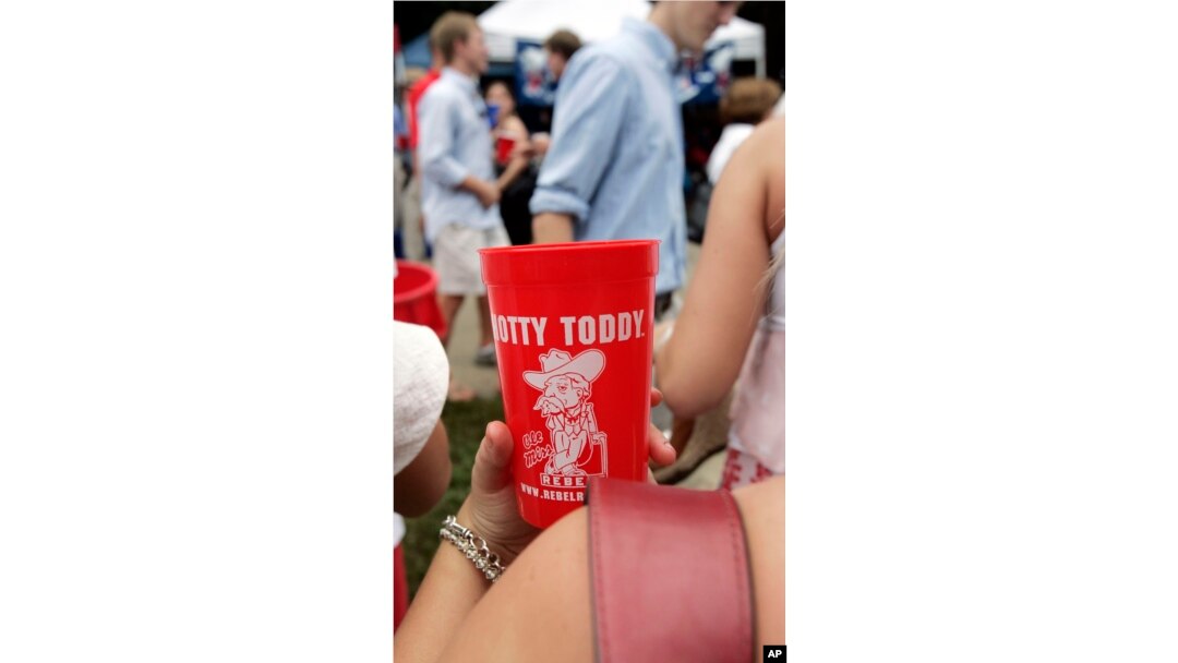 FILE - Health officials say open containers of food, shared cups of refreshment and lack of immediate hand sanitizing dispensers make tailgate gatherings, like this one at the University of Mississippi in Oxford, opportunities for students and fans to be exposed to viruses.