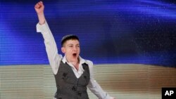 Ukrainian pilot Nadiya Savchenko, who was freed two days earlier from a Russian jail, shouts patriotic slogans as she leaves her news conference in Kyiv, May 27, 2016.