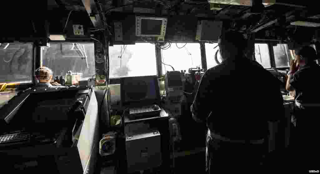 Sailors stand watch on the bridge while Tomahawk cruise missiles are launched aboard the guided-missile cruiser USS Philippine Sea. Philippine Sea is deployed as part of Carrier Strike Group 2, supporting maritime security operations and theater security cooperation efforts in the U.S. 5th Fleet area of responsibility, Arabian Gulf, Sept. 23, 2014. (U.S. Navy photo by Mass Communication Specialist 2nd Class Abe McNatt/Released)