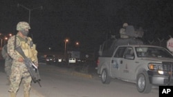 Soldiers stand guard outside a prison after a fight between rival gangs in Altamira, Tamaulipas January 4, 2012.