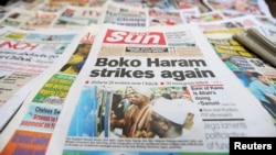 A newspaper's front-page headline reports the abduction of women from a village in northeast Nigeria, displayed at a vendor's stand along a road in Ikoyi district in Lagos, Nigeria, June 10, 2014.