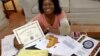 Monica Myles holds a certificate from African Ancestry Inc. showing which tribe and country her ancestors came from over 500 years ago, Aug. 28, 2003, in her Mitchellville, Md., home.