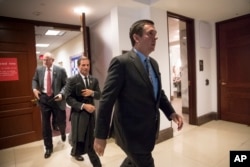 FILE - House Intelligence Committee Chairman Devin Nunes, R-Calif., followed by Rep. Chris Stewart, R-Utah, and Rep. Mike Conaway, R-Texas, far left, leave the secure area where the panel was wrapping up its inquiry into Russian meddling in the 2016 election, on Capitol Hill in Washington, Thursday, March 22, 2018.