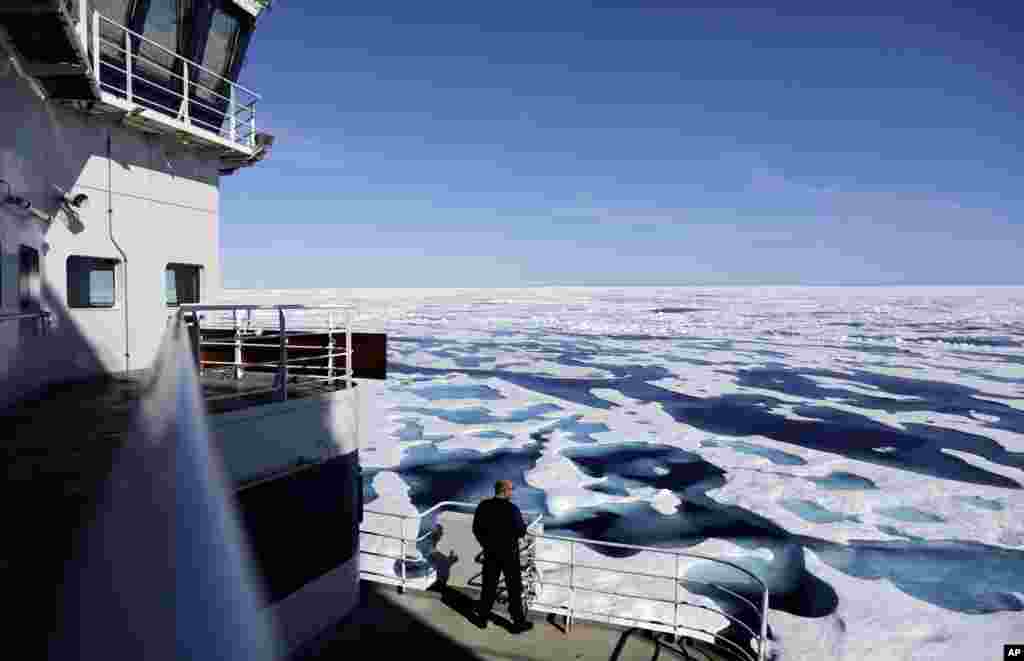 Canadian Coast Guard Capt. Victor Gronmyr looks out over the ice covering the Victoria Strait as the Finnish icebreaker MSV Nordica traverses the Northwest Passage through the Canadian Arctic Archipelago.