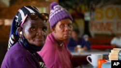 People living at the Soweto Home For The Aged practice social distancing during breakfast in Johannesburg, South Africa, Dec. 14, 2021. 