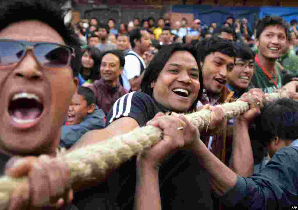 Nepalese Hindu devotees pull a wooden chariot as they take part in Bisket Jatra, a festival held in celebration of the Nepalese New Year in Bhaktapur, some 12 kms east of Kathmandu. The festival is celebrated for nine days by the ethnic Newar community in Bhaktapur.