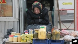 FILE - An elderly Ukrainian woman sells home made products in downtown Kiev, Ukraine, Feb. 3, 2016. 
