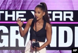 FILE - Ariana Grande accepts the award for artist of the year at the American Music Awards at the Microsoft Theater in Los Angeles, Nov. 20, 2016.