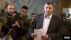 Pro-Russian rebel leader Alexander Zakharchenko prepares to casts his ballot during supreme council and presidential elections in the city of Donetsk, eastern Ukraine Sunday, Nov. 2, 2014. 